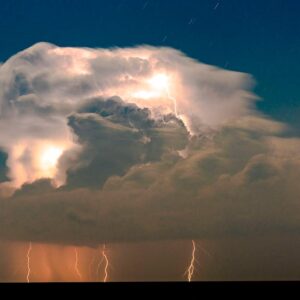 Powerful lightning illuminates dark storm clouds at night