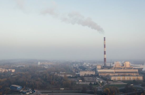 Aerial shot of a power plant emitting smoke