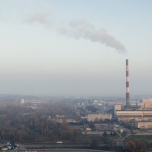 Aerial shot of a power plant emitting smoke