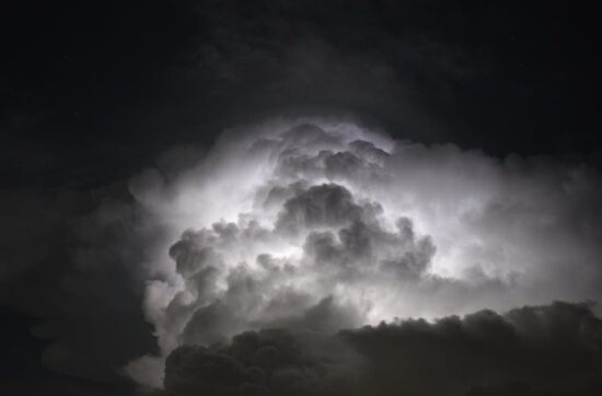 Dramatic lightning bolt over the ocean at night